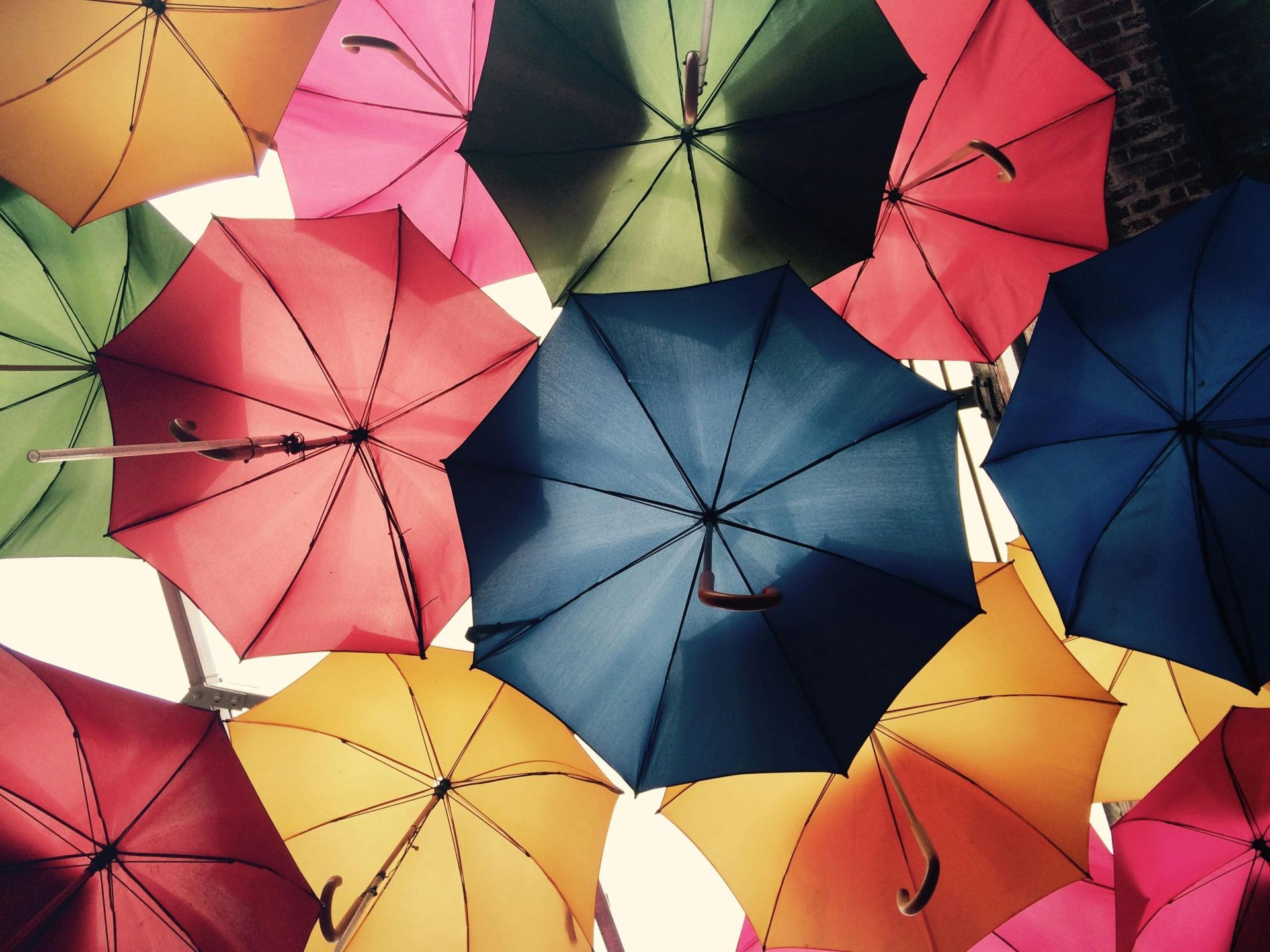 Vibrant umbrellas create a colorful canopy in Greater London, offering protection from sun and rain.