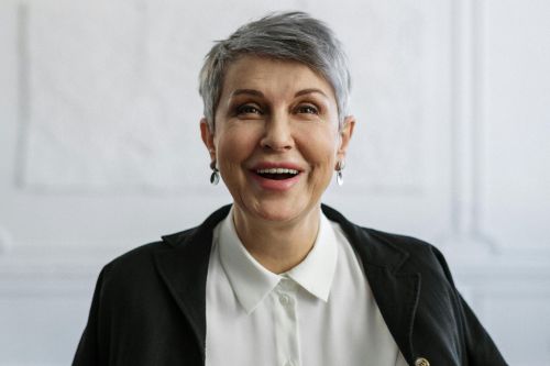 Confident woman smiling in an office, ideal for professional themes.